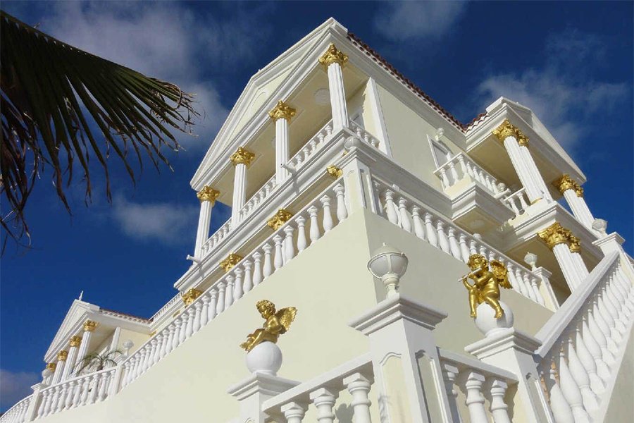 Gilded Corinthian columns and detailing adorn the soaring contemporary space within this magnificent Spanish villa.