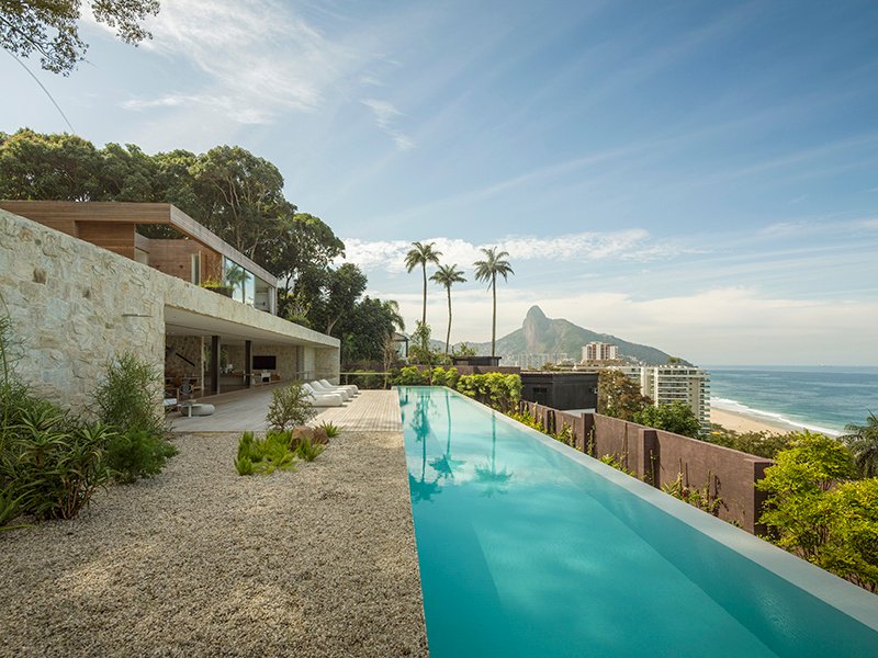 At AL House, on a steep site in the hills near Rio de Janeiro, Studio Arthur Casas captured panoramic views for its client by elevating the living areas. Photograph: Fernando Guerra