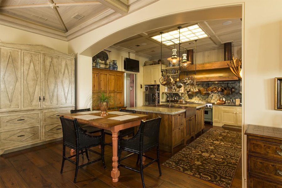Relaxing family meals or grand, formal dinner parties are easy to realize in this open and airy Savannah kitchen with its warm wood cabinetry and cheerful skylight.