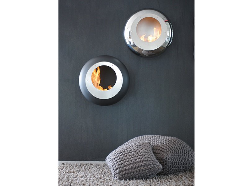 The wall-mounted Vellum fireplace by Cocoon, in a black or stainless-steel finish, has a diameter of 23.7 inches and burns for up to six hours.