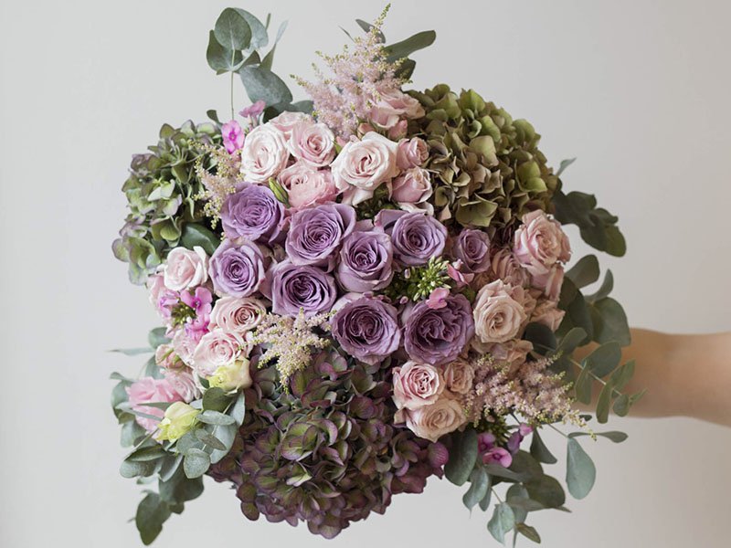 For a vintage-style bouquet, Front Row uses lilac, eucalyptus, hydrangea, and spray roses, creating a rustic beauty.