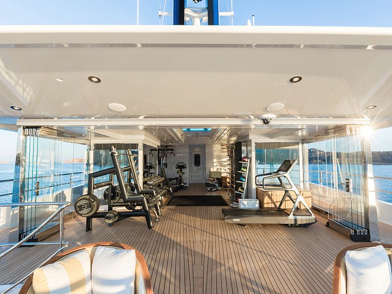 Even the glass-walled exercise room on Joy provides a generous outlook of the sea beyond.