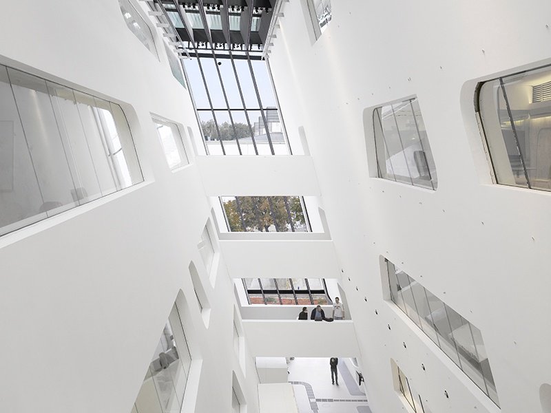 While the exterior edges of Zaha Hadid’s library at the University of Economics Vienna are cut sharply, the interior spaces join together in a flowing free-form. Photograph: Roland Halbe