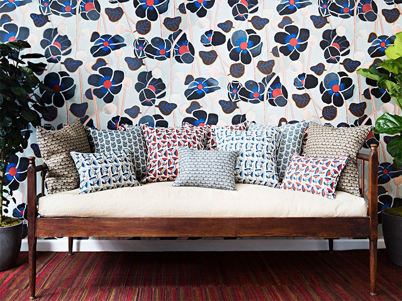 An assortment of Wayne Pate’s designs, including Poppies Noir wallpaper and throw pillows in a variety of patterns. Photograph: Brittany Ambridge.