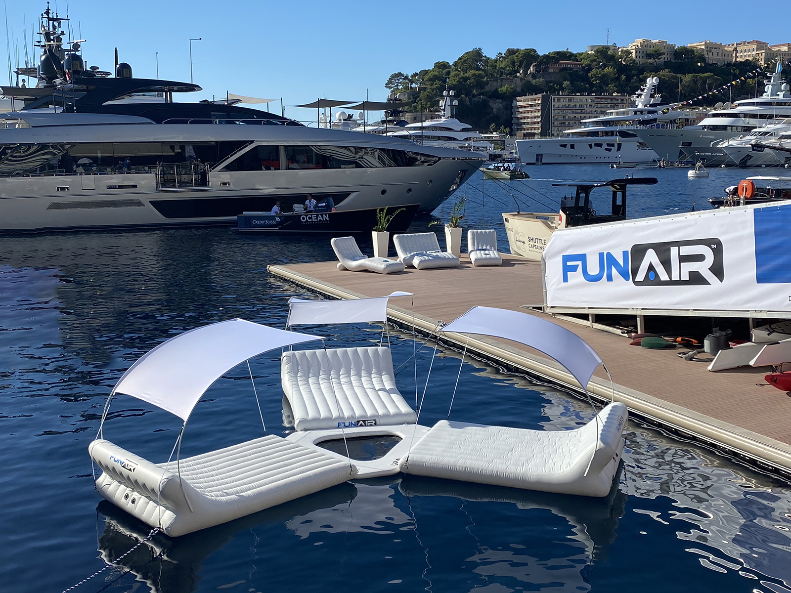 Three floating loungers connected together on the water, some of the best superyacht toys for relaxing