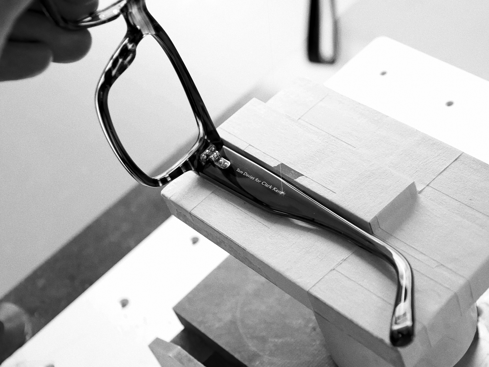 Black glasses frame for film Superman being constructed