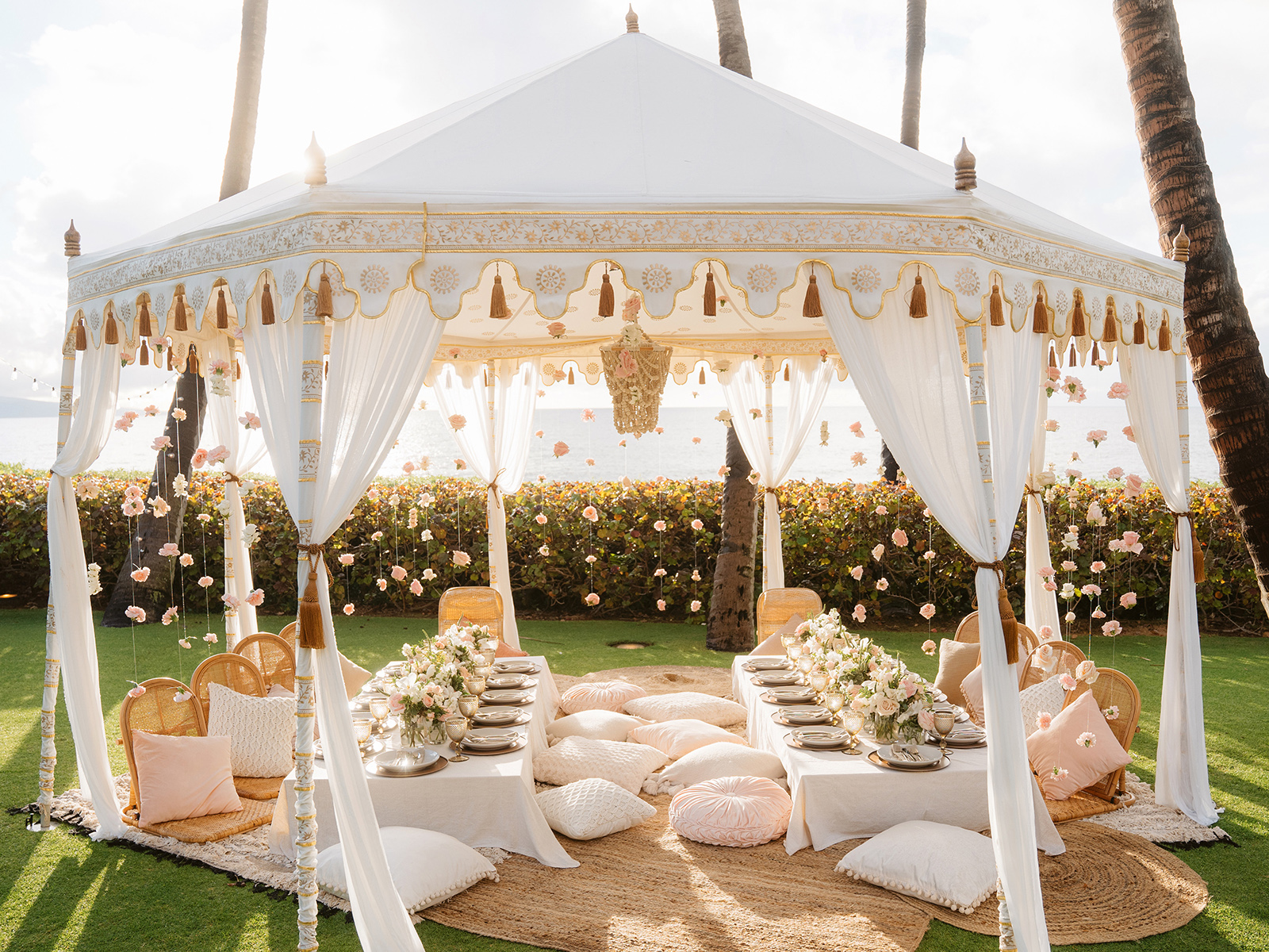 Cream tent with low picnic tables and cushions underneath