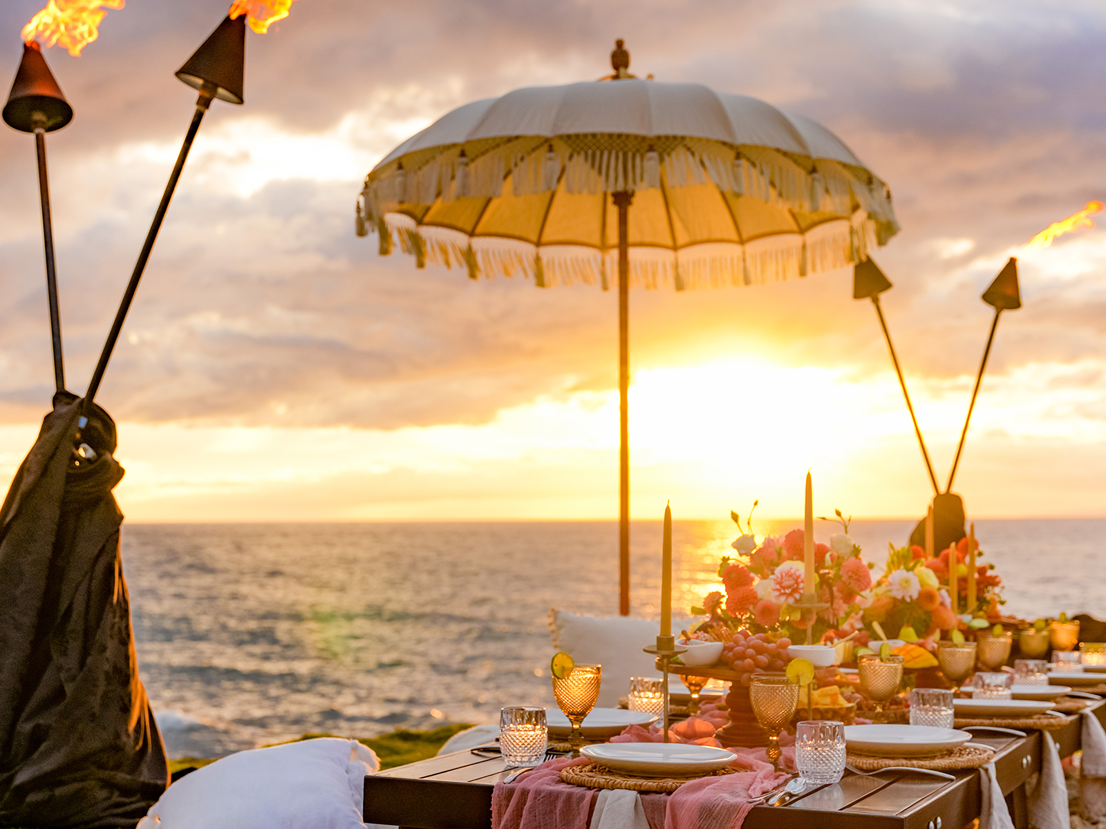 Low table picnic setting overlooking the sun setting into the sea