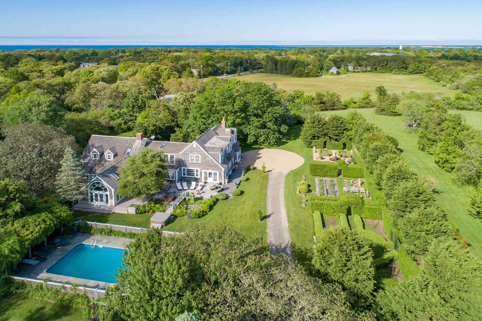 This picture-postcard property on five acres in the historic seaside resort of Martha’s Vineyard comprises three Shingle-style residences, a swimming pool, and formal gardens.